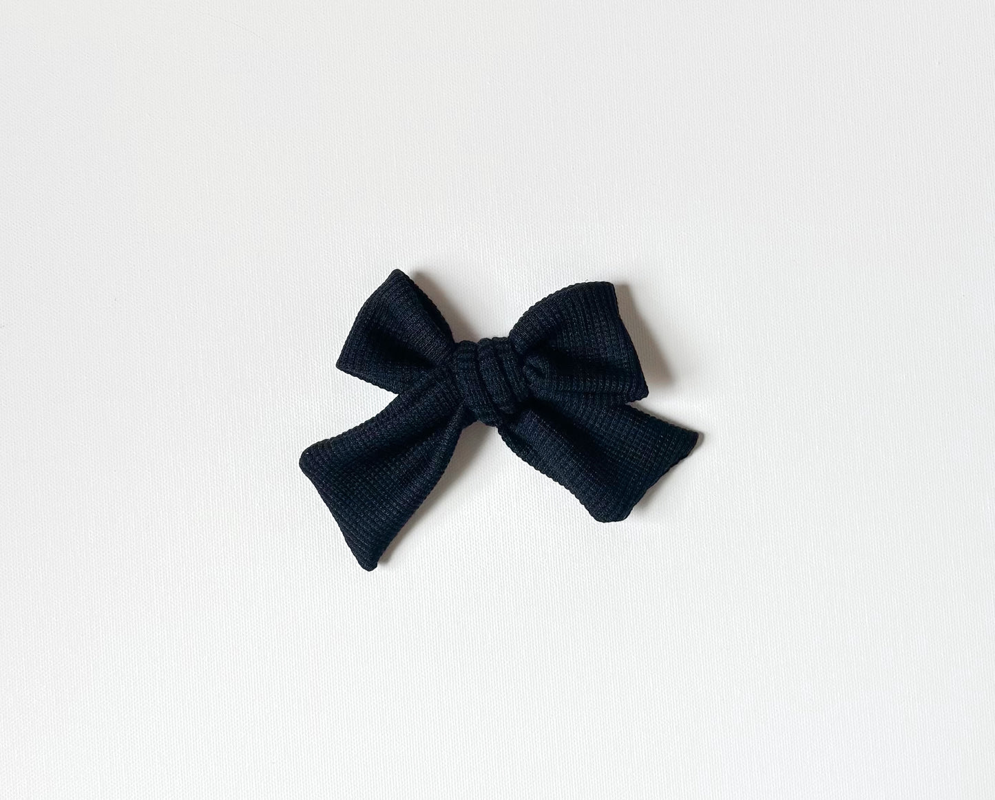 Black waffle knit bow clip